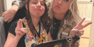Two girls with peace signs - square