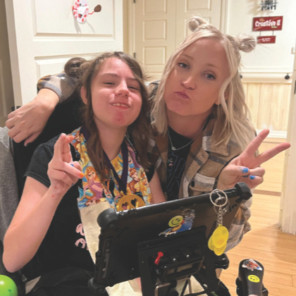 Two girls with peace signs - square