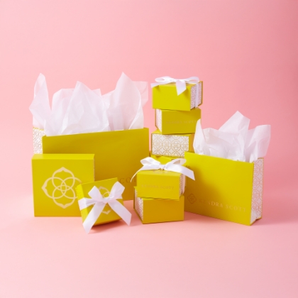 Kendra Scott presents with pink background