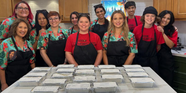 Photo of volunteers in red shirts in the kitchen